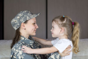 Military Mother Holding Daughter